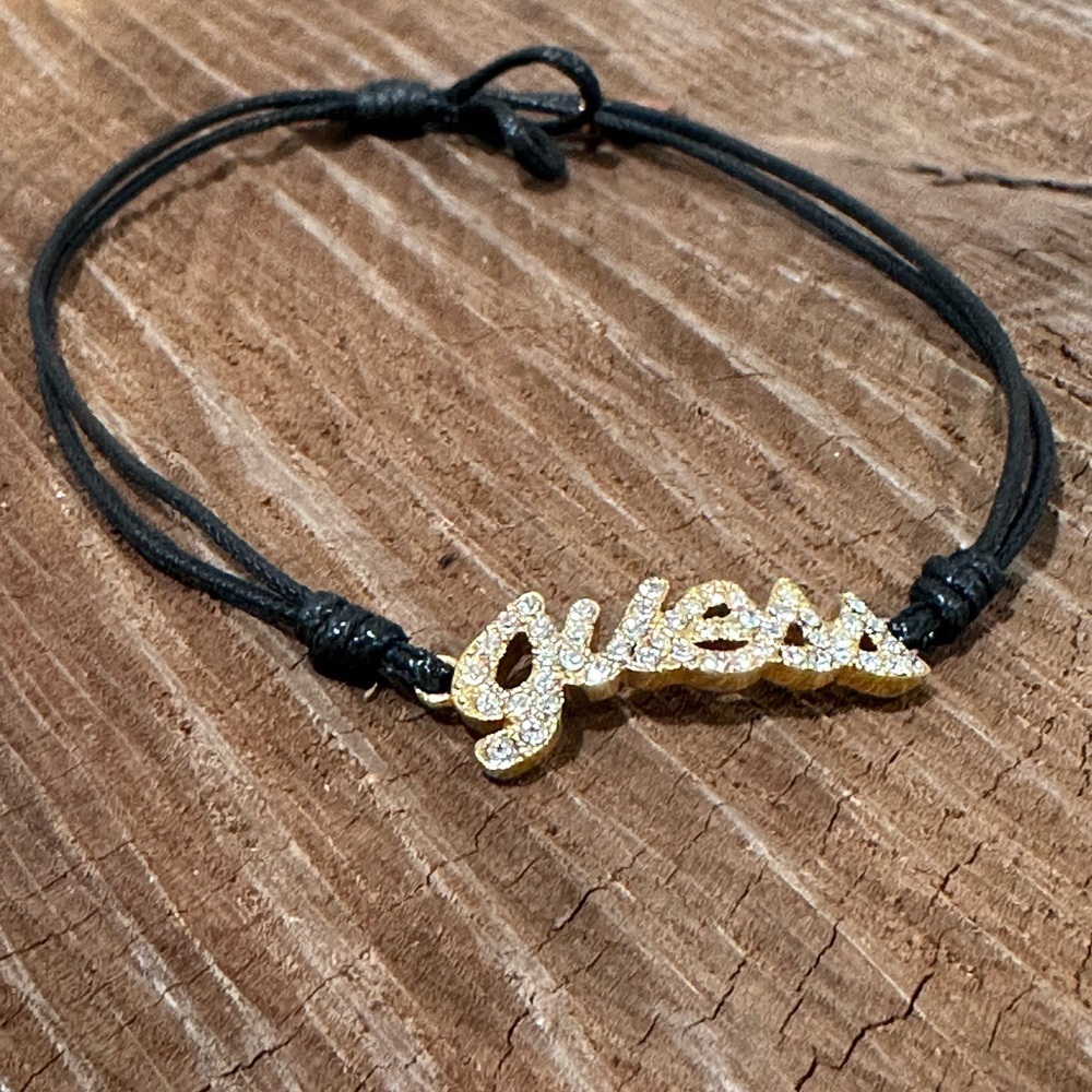 Guess Gold Crystal Script Bracelet with Black Cord